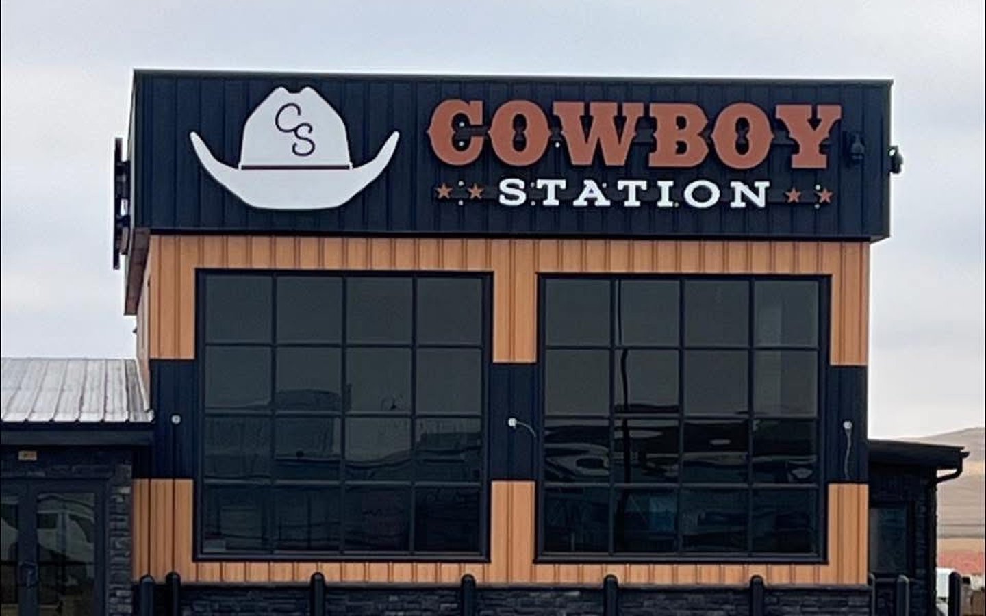 The Cowboy Station storefront and its tall windows under the sign.